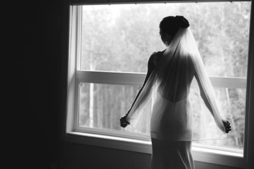 Bride has a moment as she gets ready at a Calgary Wedding