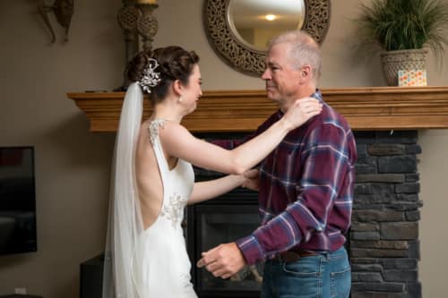 Father and daughter share a moment as they both cry during first look at Calgary wedding